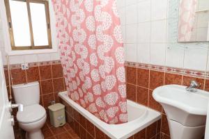 a bathroom with a toilet and a sink and a shower curtain at Spacious 2 BR appartment near mall -Internet 1Gbps in Paphos +28 photos