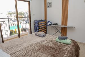 a bedroom with a bed with two towels on it at Spacious 2 BR appartment near mall -Internet 1Gbps in Paphos