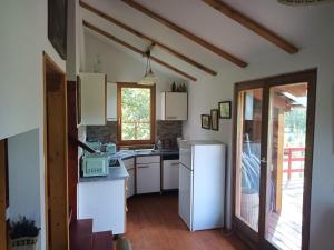 a kitchen with a sink and a refrigerator at ZegZug apartman in Pankasz