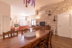 a living room with a wooden table and a dining room at Villa Icaria in Carovigno