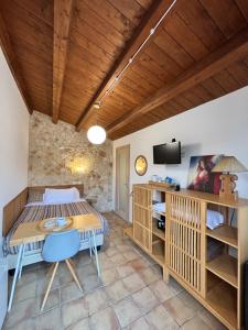 a room with a bed and a table and a tv at Artemisia Resort in Puntarazzi