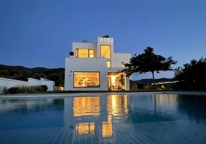 a large white house with a swimming pool in front of it at Zihuatanejo in Granada