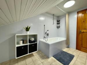 a bathroom with a bath tub and a sink at FeWo Taube in Schammels dorf am Brauereienweg Platz für 7 Personen in Litzendorf +45 photos