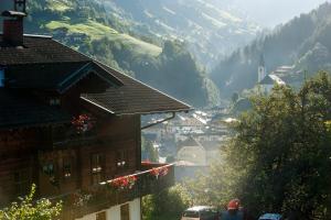 a view of a valley with a town and mountains at Reitbauernhof in Grossarl +10 photos