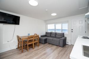 a living room with a couch and a table at Oceanfront - Steps to Pier & Beach - Free Onsite Parking in White Rock