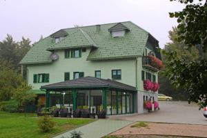 a large house with a green roof at VILLa LIKA A NNEX in Plitvička Jezera