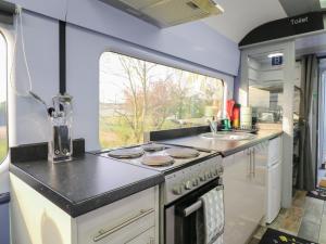 an rv kitchen with a stove and a sink at The Carriage Ely Penzance in Ely