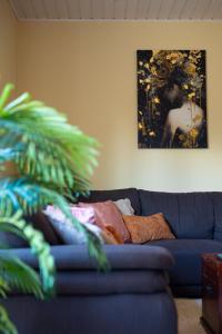 a blue couch in a living room with a painting at Ninase Villa in Ninaze