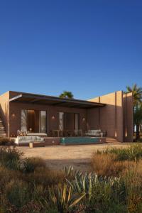 a house with a pool in front of it at Amerruk, Marrakech, Autograph Collection in Marrakesh