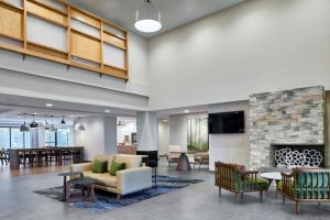 a lobby with a couch and a fireplace at Fairfield by Marriott Inn & Suites LaGrange in La Grange