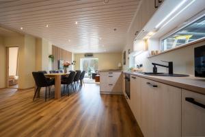 a kitchen and dining room with a table and chairs at Ninase Villa in Ninaze