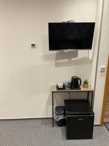 a flat screen tv sitting on top of a table at Gasthof und Pension Bernburger Point in Bernburg