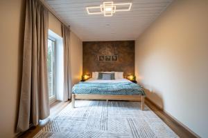a bedroom with a bed and a large window at Ninase Villa in Ninaze