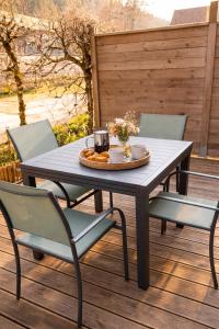a table and four chairs on a wooden deck at Au Doubs lac, Cosy 4 pers Terrasse ,Ski et Nature in Malbuisson