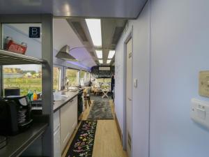 a kitchen and living room in a train car at The Carriage Ely Paddington in Ely