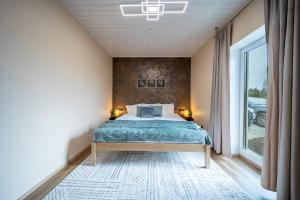 a bedroom with a bed and a large window at Ninase Villa in Ninaze +14 photos