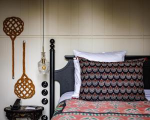 a bedroom with a bed and a table with a lamp at Domaine de Locguénolé & Spa - Relais & Chateaux in Kervignac +290 photos