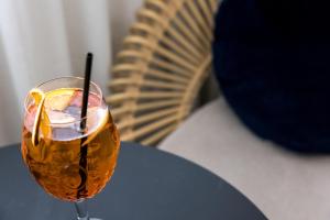 a drink in a glass sitting on a table at Le Celtique & Spa in Carnac