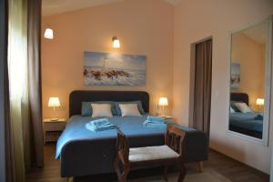 a bedroom with a blue bed and a chair at Casa Providenca in Kaštelir +34 photos