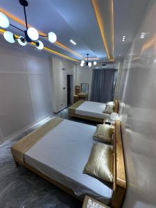 a bedroom with two beds in a room at Résidence Madior F2 in Dakar