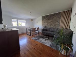 a living room with a couch and a table at Ferienwohung Else Sankt Wendel in Sankt Wendel