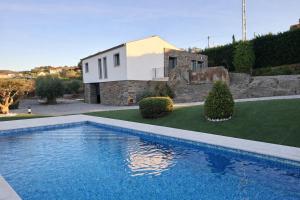 a villa with a swimming pool in front of a house at The Douro Nest in Valença do Douro