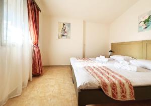 a bedroom with a large bed and a window at Арт Спектър Камп in Bratsigovo
