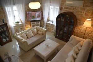 a living room with two couches and a tv at Casa Providenca in Kaštelir