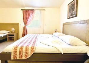 a large bed in a room with a window at Арт Спектър Камп in Bratsigovo +17 photos