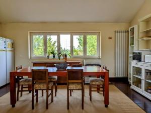 a kitchen with a dining room table and chairs at Casa de Maria in Cotovia +8 photos