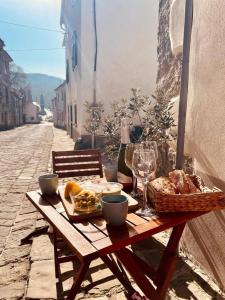 a picnic table with a basket of food on a street at Casa Stella in Draguć