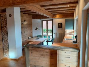a kitchen and dining room with a large wooden table at Ferienhaus Träglhof in Hirschau