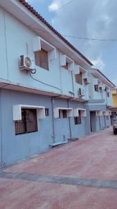 a white building with windows on the side of it at Q2Shortlet Apartment in Isheri-Olofin