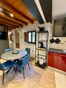 a kitchen with a table and chairs in a room at Vicoletto4-Centro storico Verona con Parking in Verona +4 photos