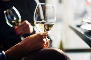 a woman holding a glass of white wine at Sheraton Rockville Hotel in Rockville