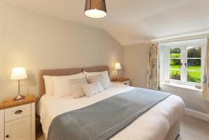 a bedroom with a large bed and a window at Stockham Farm Dulverton in Dulverton
