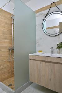 a bathroom with a sink and a mirror at Pharos Rooms in Ilia