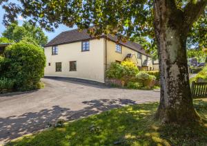 a house with a tree in front of it at Old Malthouse Monksilver in Monksilver