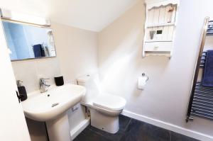 a white bathroom with a toilet and a sink at Stockham Farm Dulverton in Dulverton +35 photos