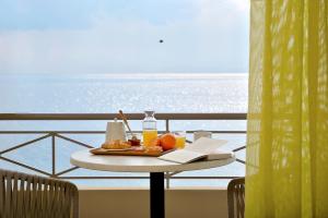 a tray of food on a table on a balcony at Pharos Rooms in Ilia