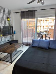 a living room with a couch and a table at playa ancha in San Luis de Sabinillas