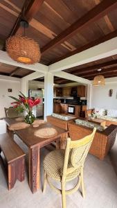 a dining room with a wooden table and chairs at Finca Flor de Maria in El Zaino