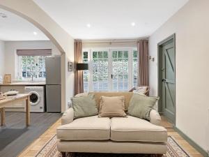 a living room with a couch and a table at Worthy Cottage Porlock Weir in Porlock