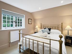 a bedroom with a bed and a window at Worthy Cottage Porlock Weir in Porlock