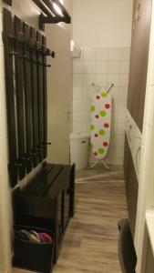 a bathroom with a toilet and a baseball bat at Apartment Patr&iacute;cia with garden in Budapest