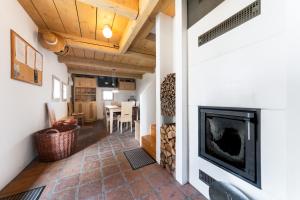 a living room with a fireplace and a dining room at Chalet Němčice in Němčice
