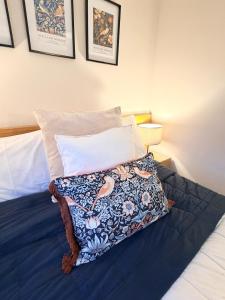 a bedroom with a bed with a blue comforter at The Inn at Emmington in Chinnor