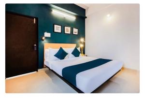 a bedroom with a large bed with a blue wall at Hotel Silverkey luxury Rooms in Hyderabad