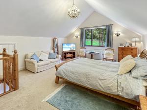 a bedroom with a bed and a living room at Bridlecott Monksilver in Monksilver