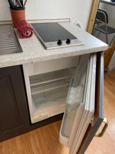 an open refrigerator with a laptop on top of it at Bitihorn in Beitostøl